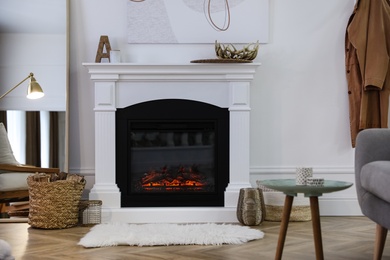 Beautiful living room interior with fireplace near white wall