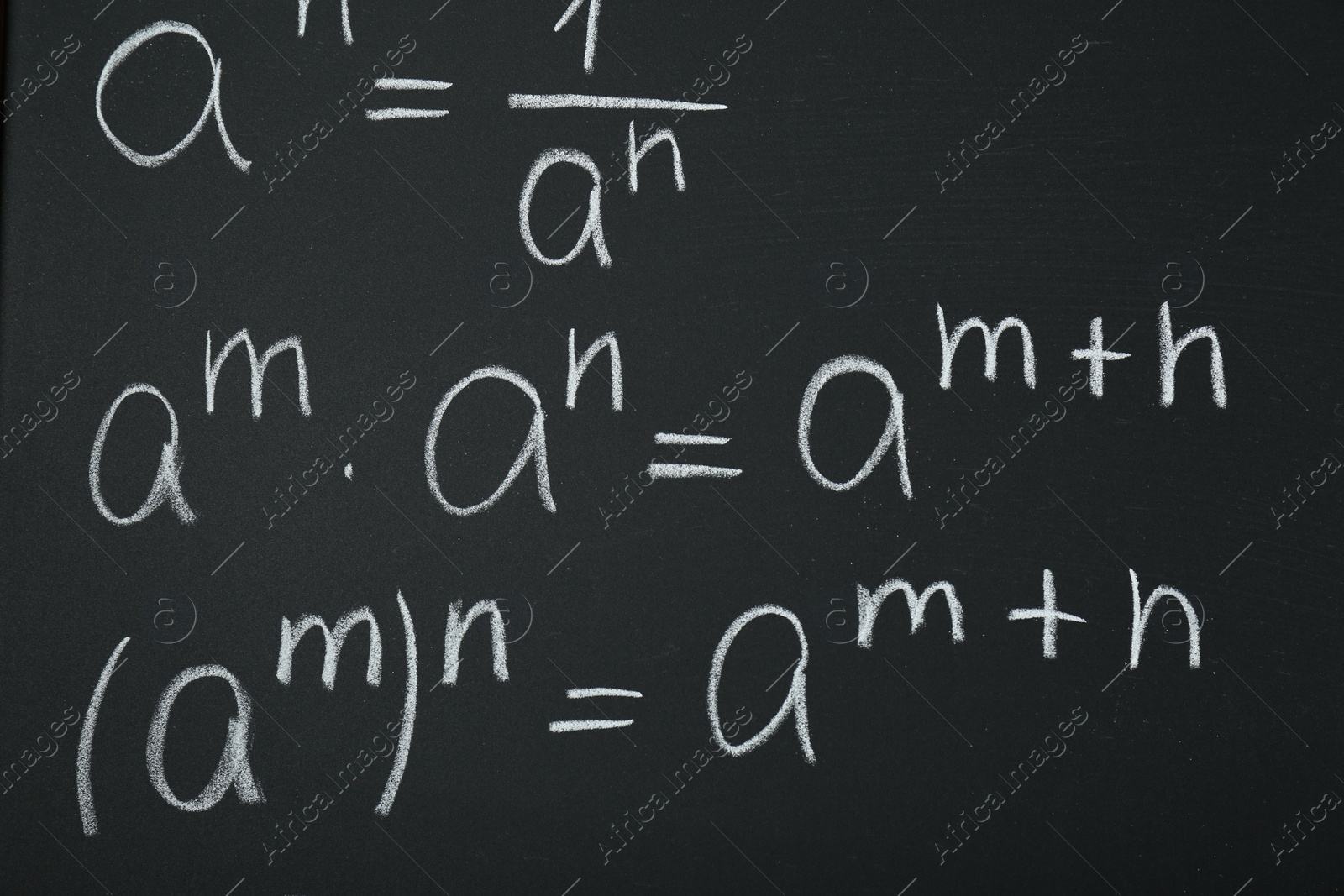 Photo of Many different math formulas written on chalkboard, closeup