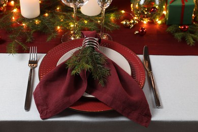 Photo of Christmas place setting with festive decor on table
