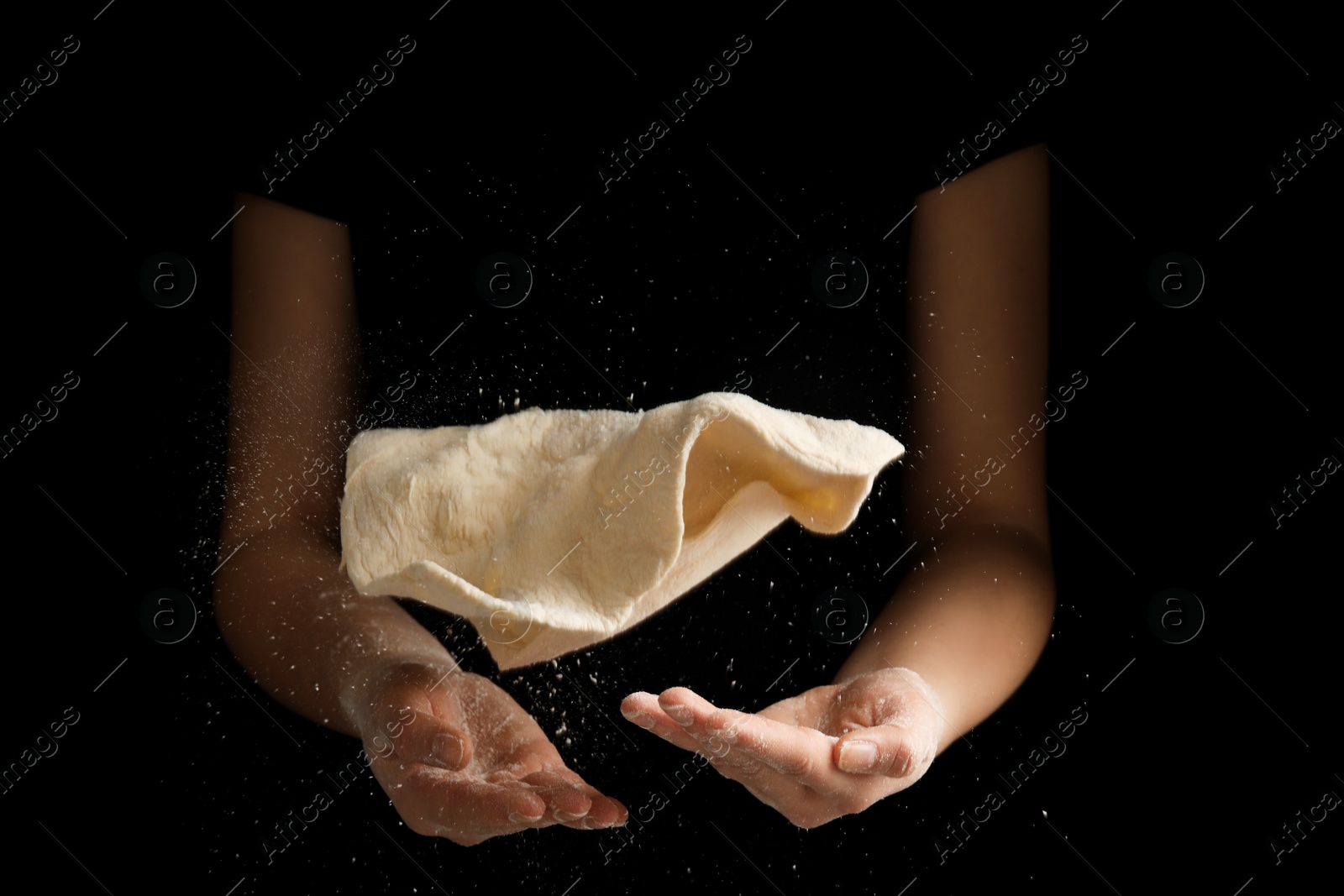 Photo of Woman preparing dough for pizza on black background, closeup