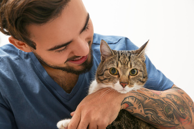 Photo of Happy man with cat at home. Friendly pet