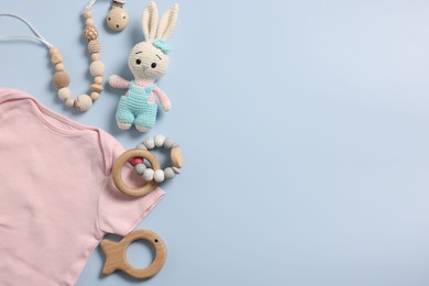 Photo of Different baby accessories on light blue background, flat lay. Space for text