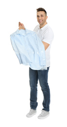 Man holding hanger with shirt in plastic bag on white background. Dry-cleaning service
