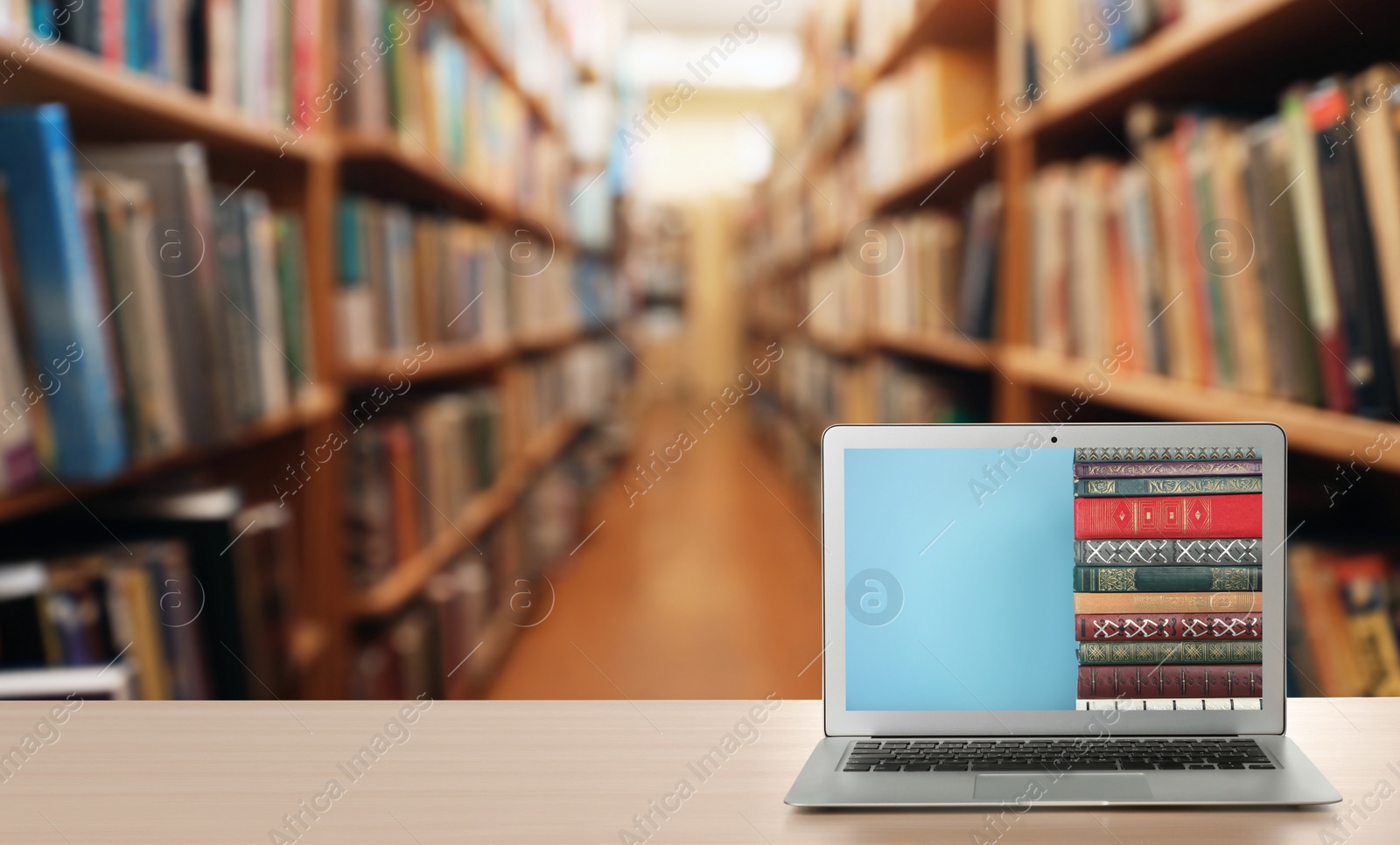 Image of Digital library concept. Modern laptop on table indoors, space for text