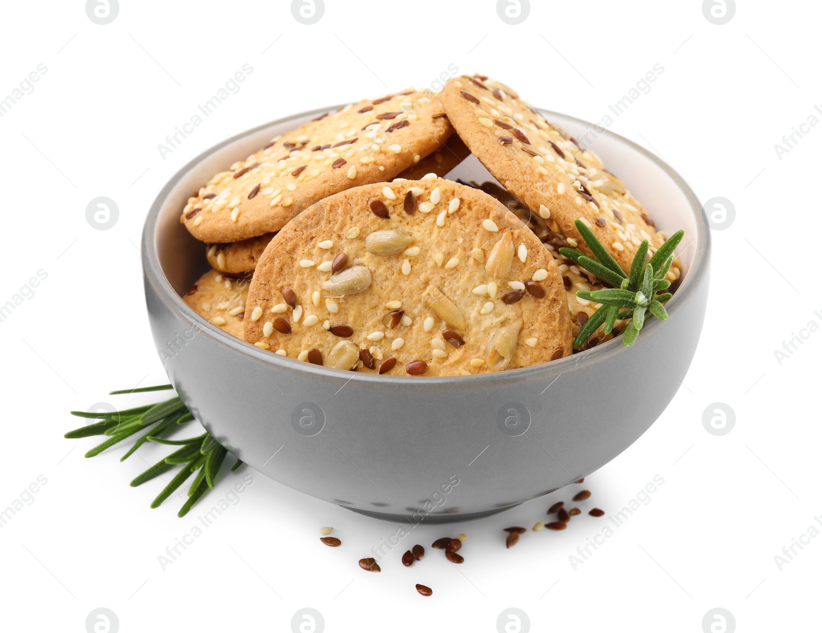 Photo of Round cereal crackers with flax, sunflower, sesame seeds and rosemary in bowl isolated on white