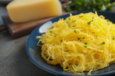 Photo of Plate with cooked spaghetti squash on table, closeup