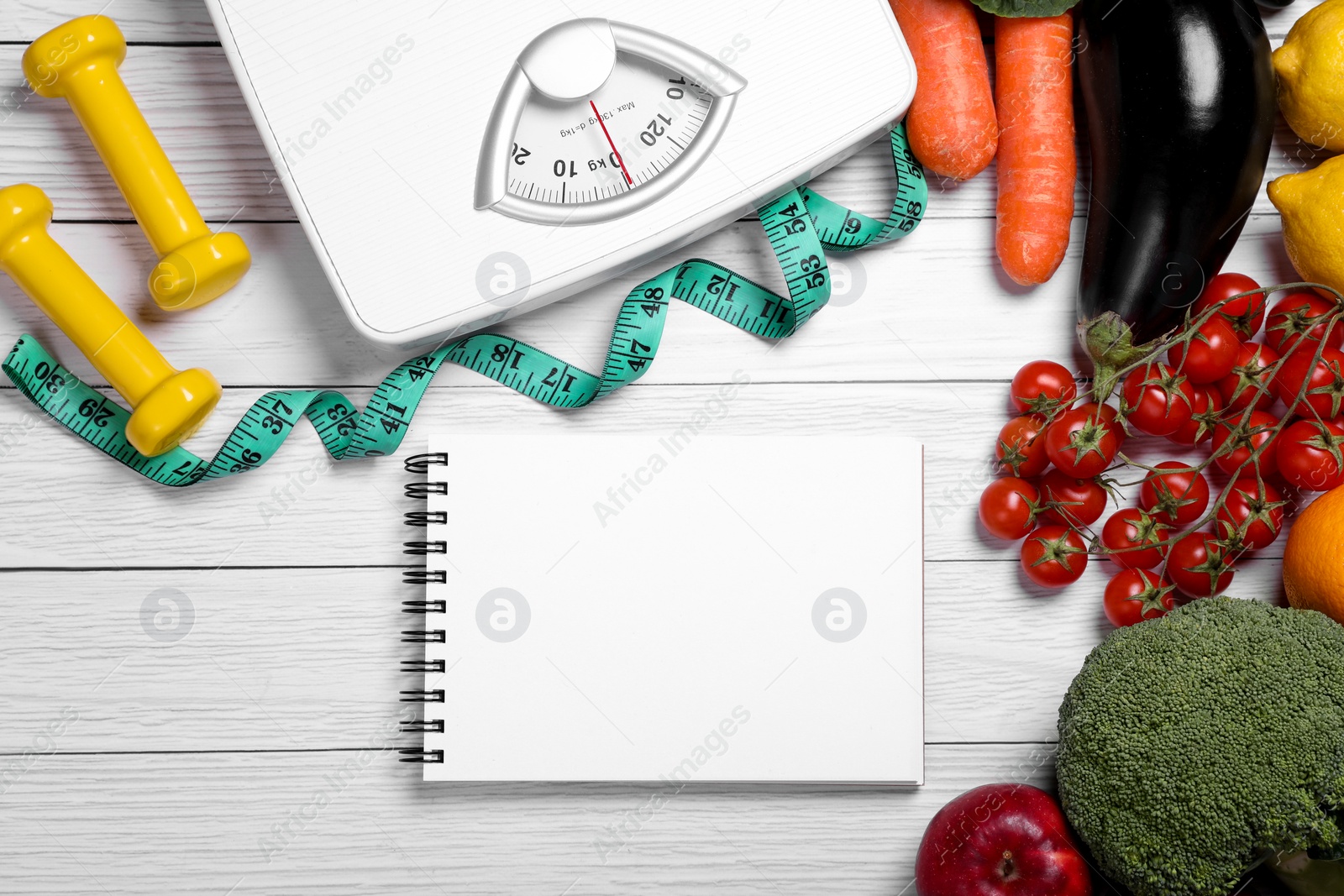 Photo of Measuring tape, notebook, fresh fruits and vegetables on white wooden table, flat lay. Low glycemic index diet