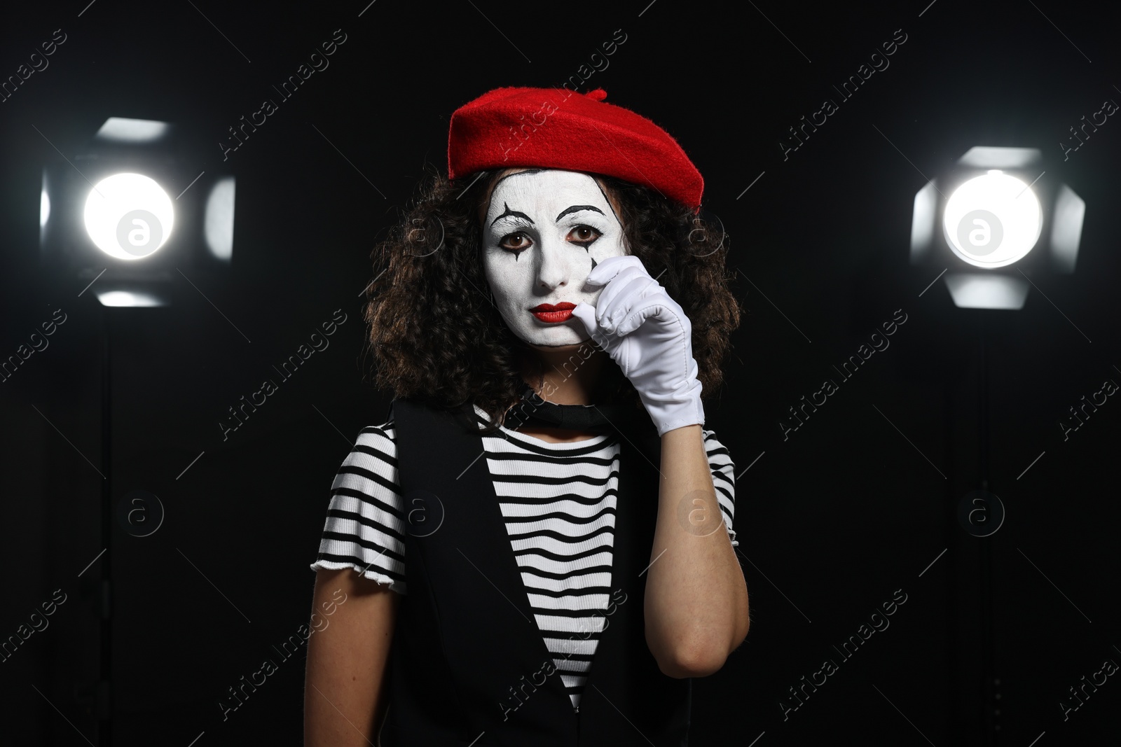 Photo of Young woman in mime costume performing on stage