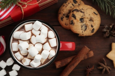 Photo of Flat lay composition with delicious marshmallow cocoa on wooden table