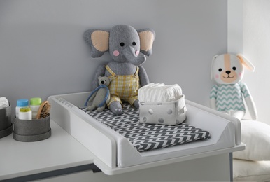 Photo of Modern changing table in baby room. Interior design