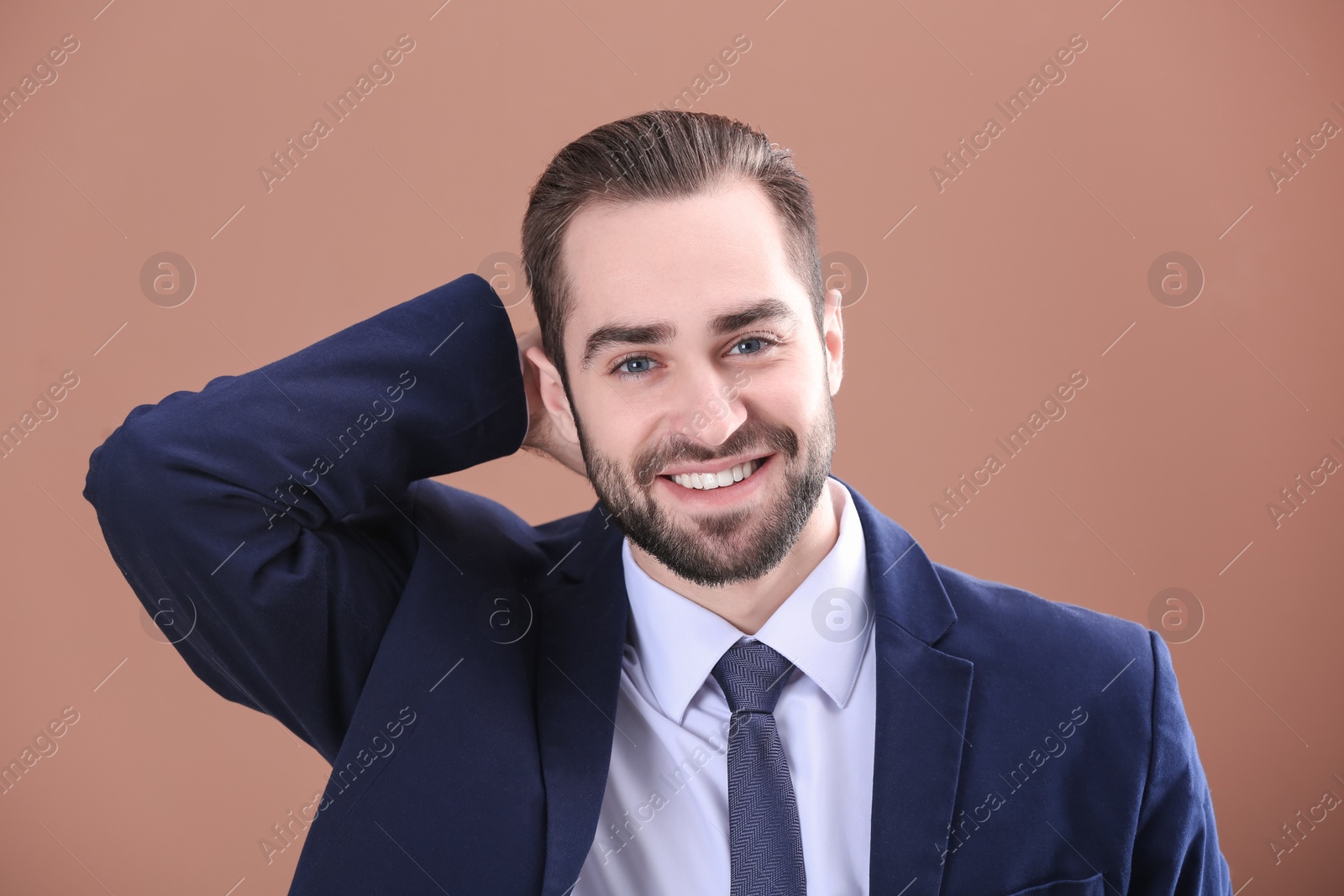 Photo of Portrait of young businessman with beautiful hair on color background