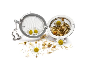 Infuser with dry herbal tea and chamomile flowers on white background