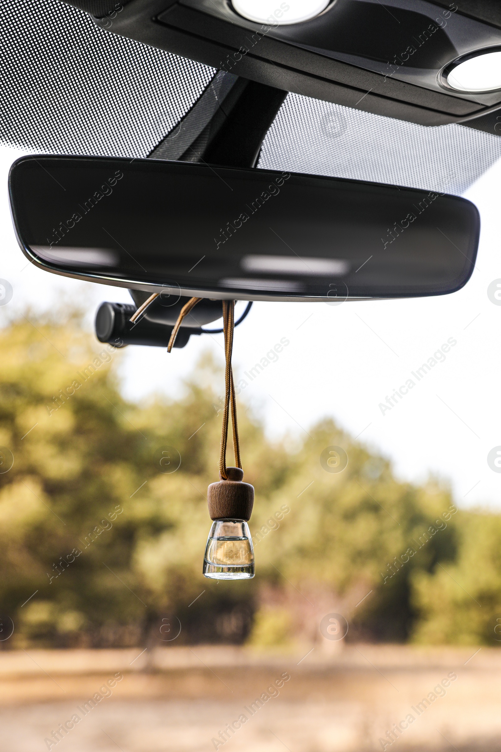 Photo of Air freshener hanging on rear view mirror in car