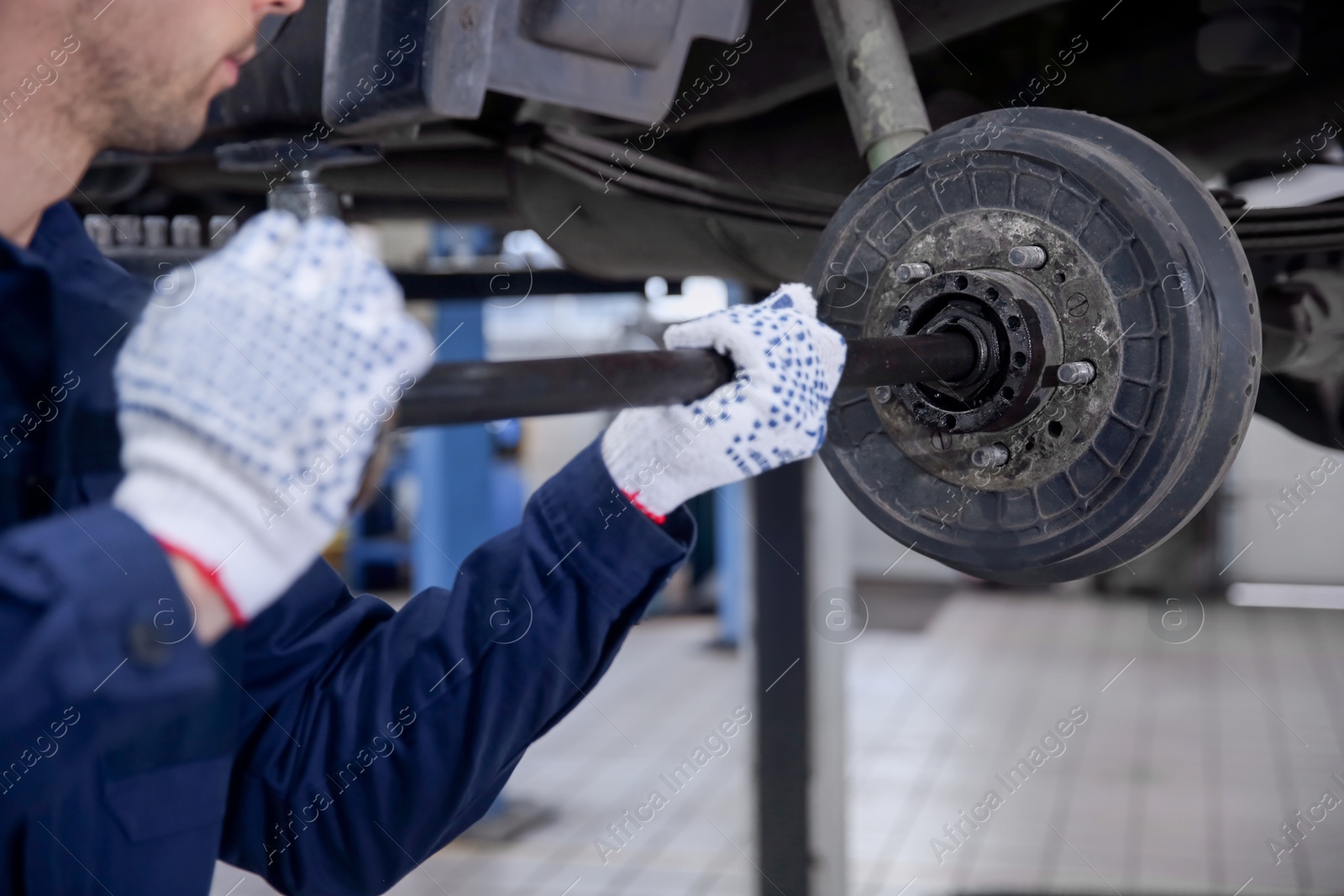 Photo of Mechanic changing wheel at tire service, closeup