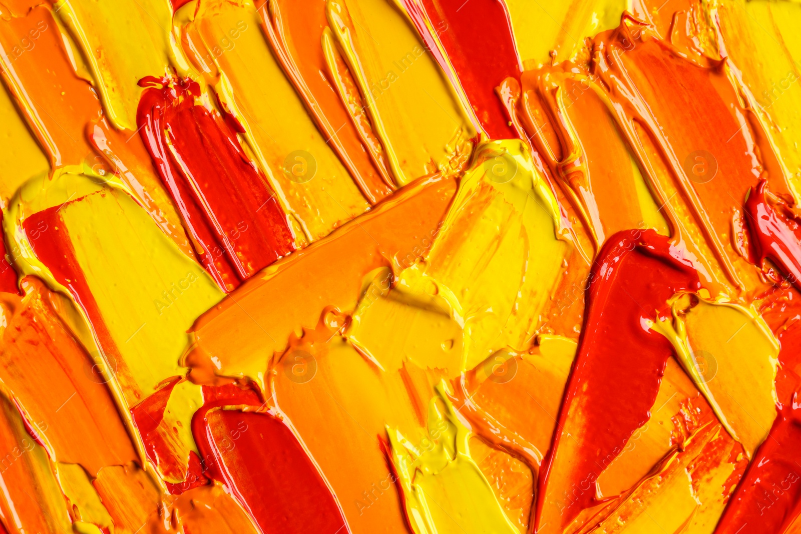 Photo of Beautiful strokes of colorful oil paints as background, closeup