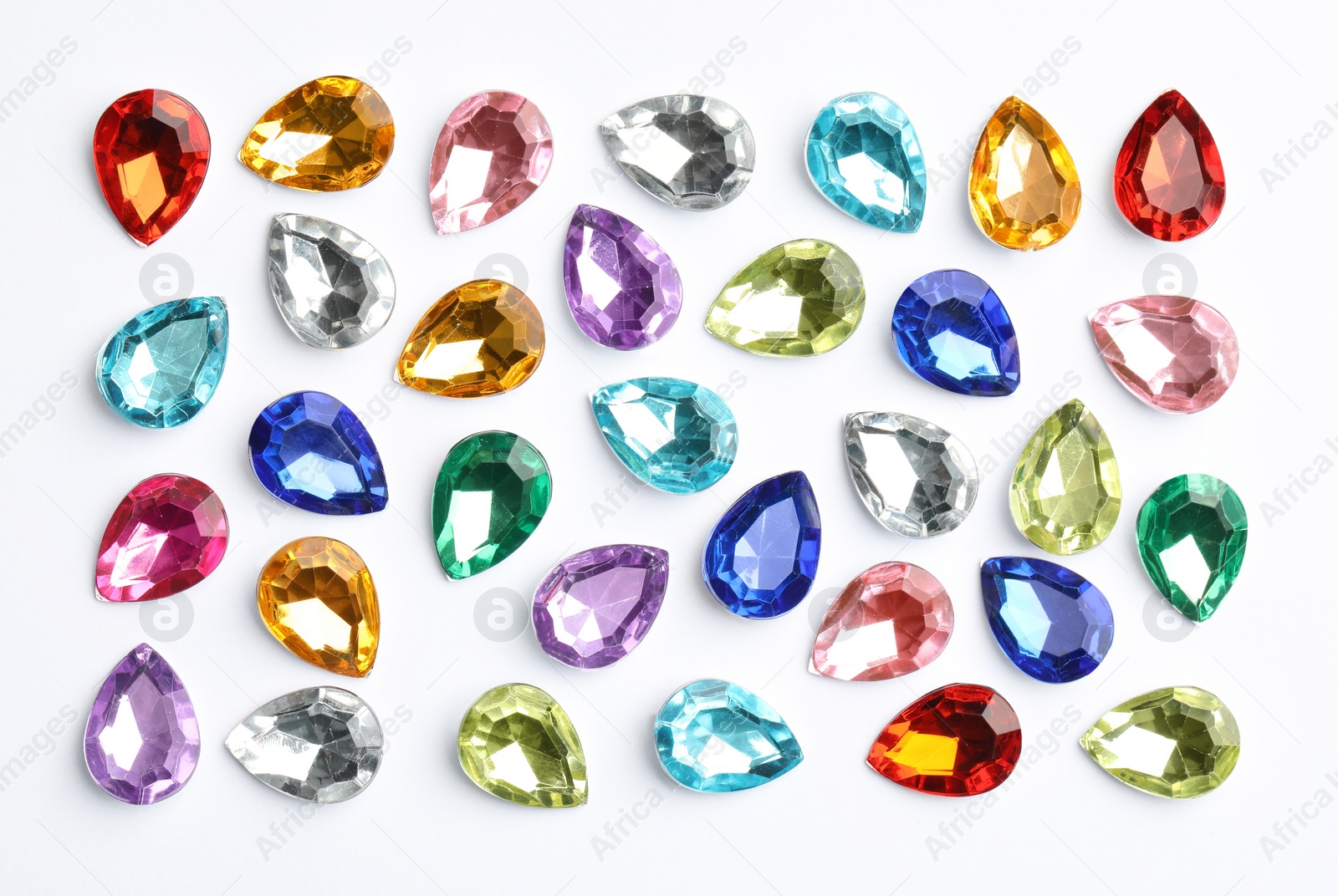 Image of Different beautiful gemstones on white background, top view