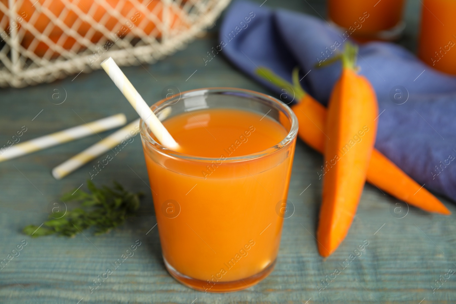 Photo of Glass of freshly made carrot juice on wooden table