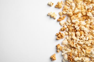 Photo of Delicious caramel popcorn on white background, top view