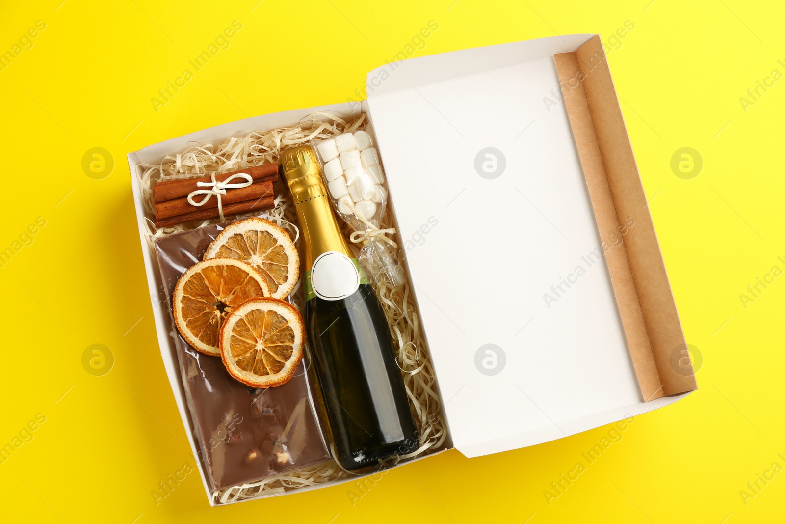 Photo of Stylish gift set on yellow background, top view