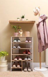 Stylish dressing room interior with shoes in storage unit