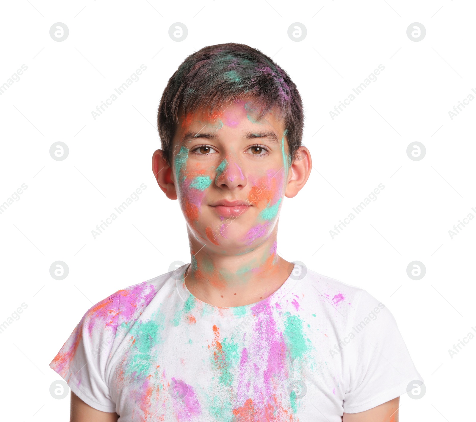 Photo of Teenage boy covered with colorful powder dyes on white background. Holi festival celebration