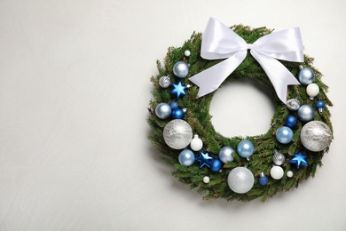 Beautiful Christmas wreath on light background, top view. Space for text