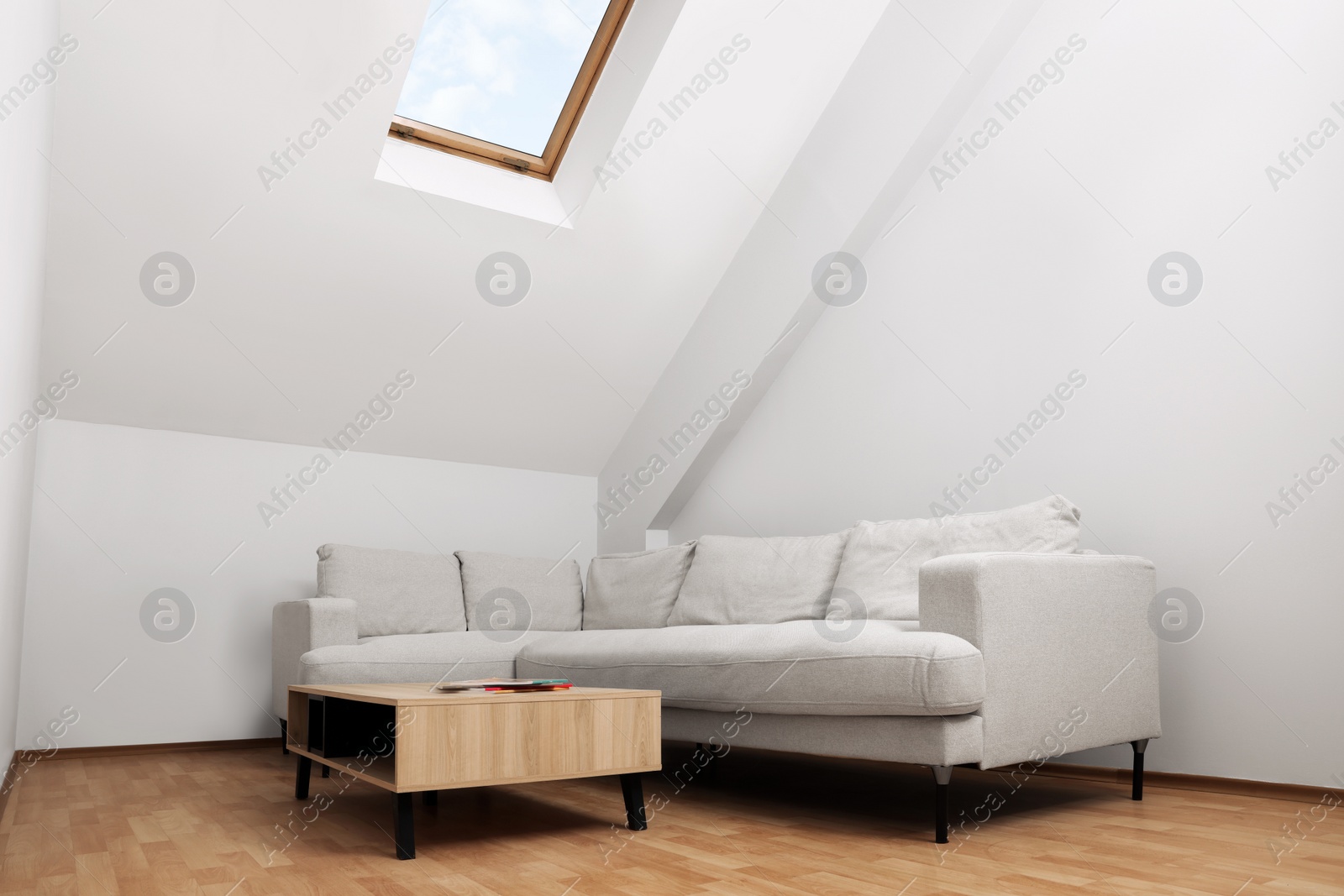 Photo of Attic room interior with slanted ceiling and furniture