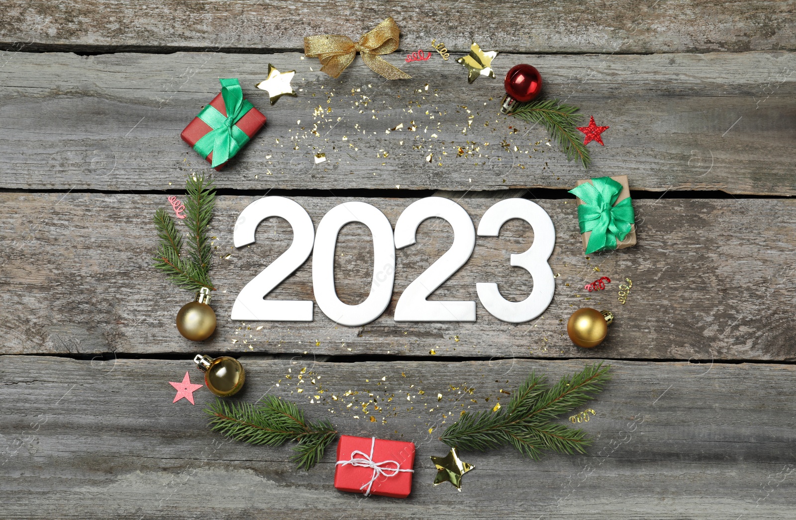 Photo of Flat lay composition with number 2023 and festive decor on wooden background. Happy New Year