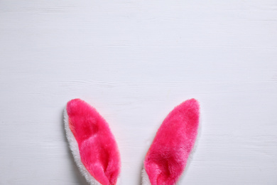 Photo of Decorative bunny ears and space for text on white wooden background, flat lay. Easter holiday