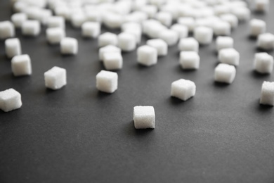 Photo of Refined sugar cubes on grey background