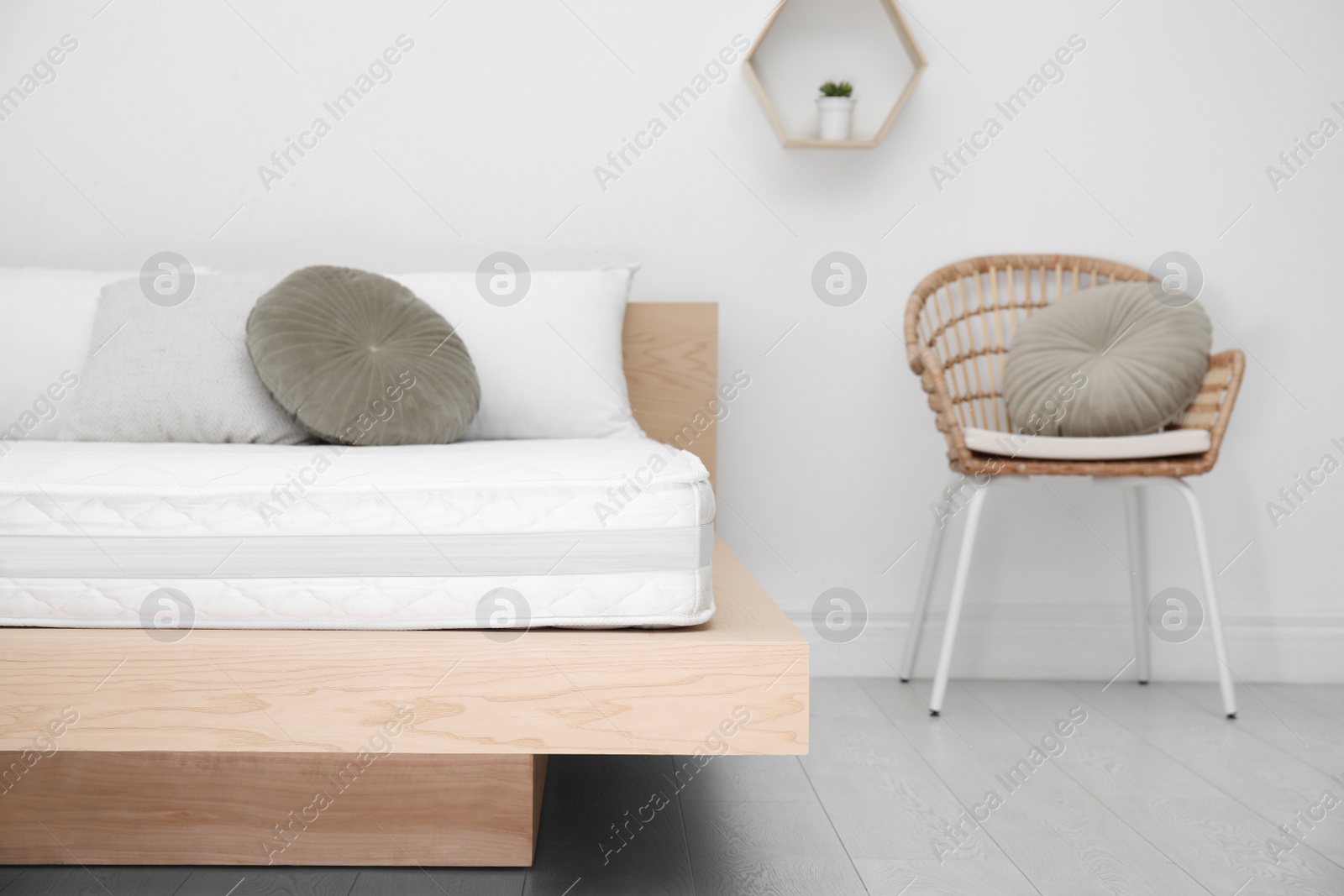 Photo of Wooden bed with soft white mattress and pillows indoors