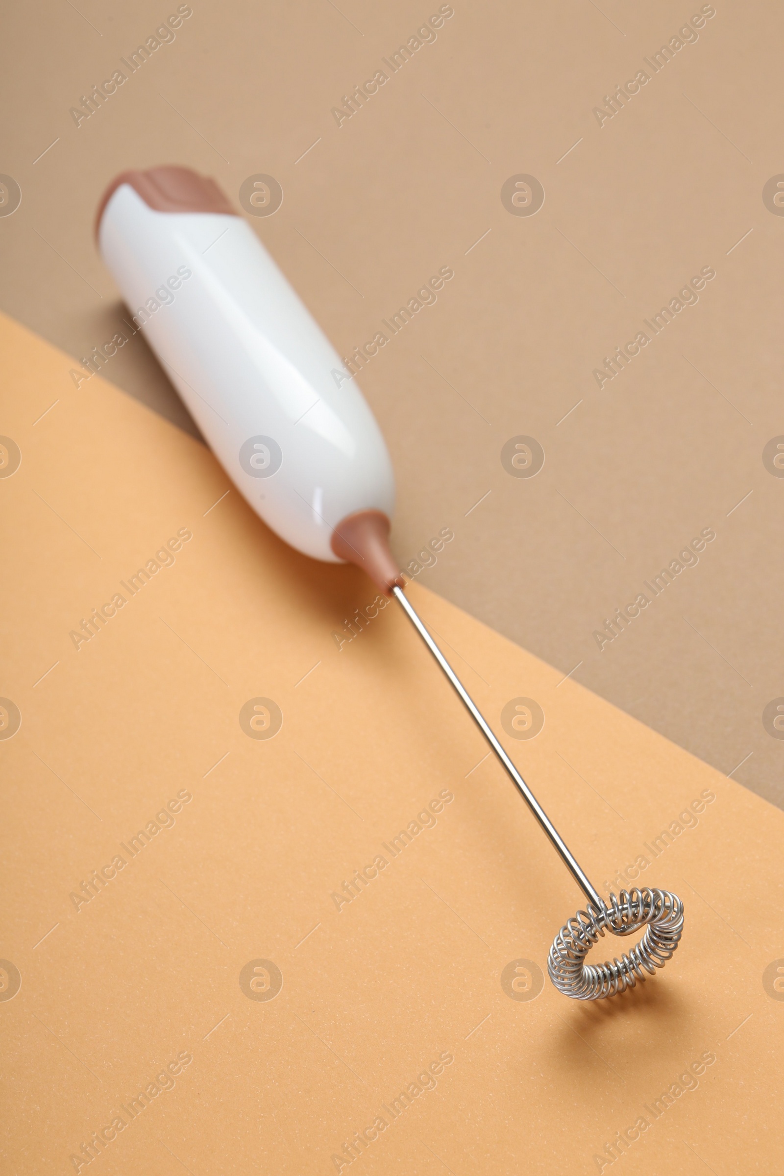 Photo of White milk frother wand on color background