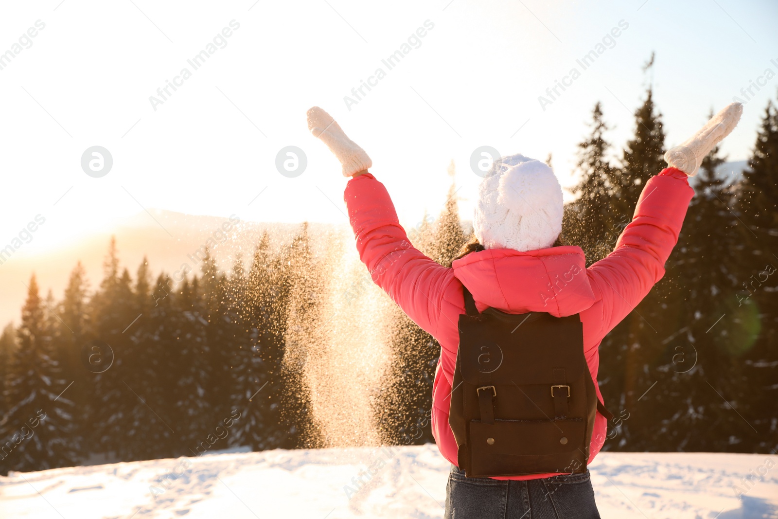 Photo of Young woman having fun outdoors on snowy winter day