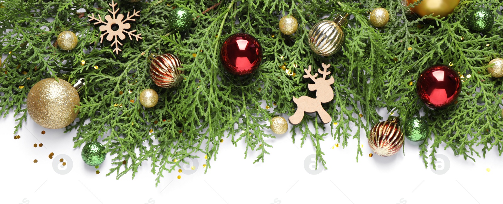 Photo of Thuja branches with Christmas decorations on white background, flat lay