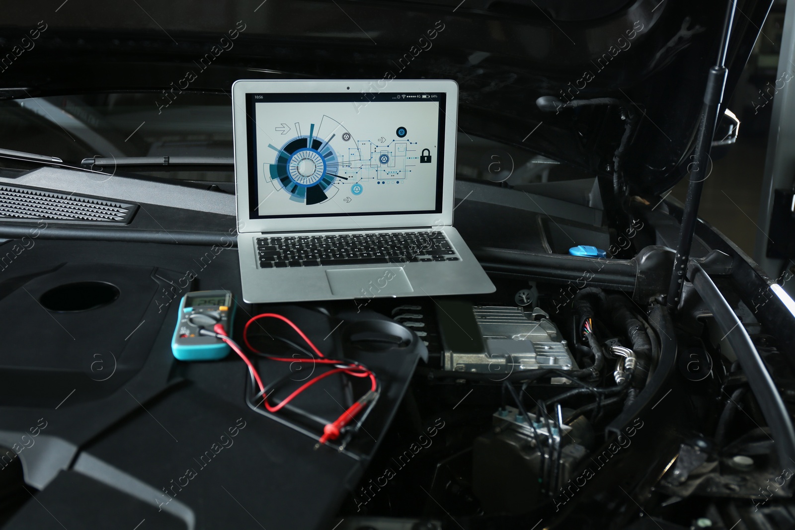 Photo of Laptop with diagram on auto engine. Modern car diagnostic