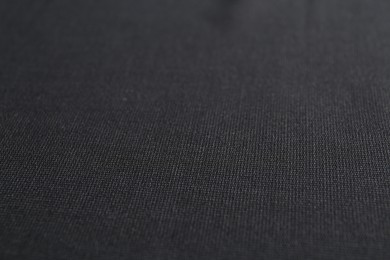 Photo of Texture of dark fabric as background, closeup