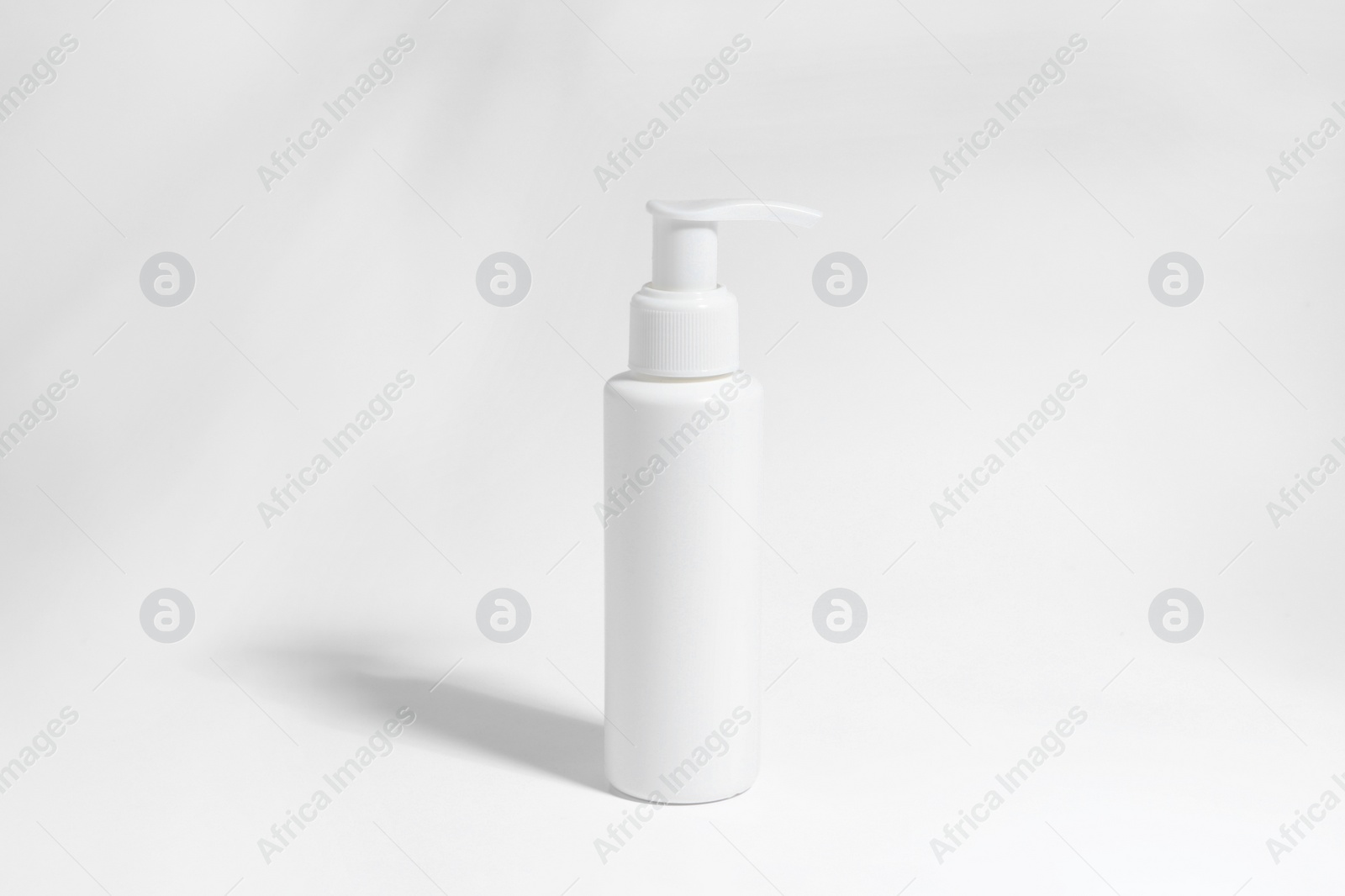 Photo of Bottle with cosmetic product on white background