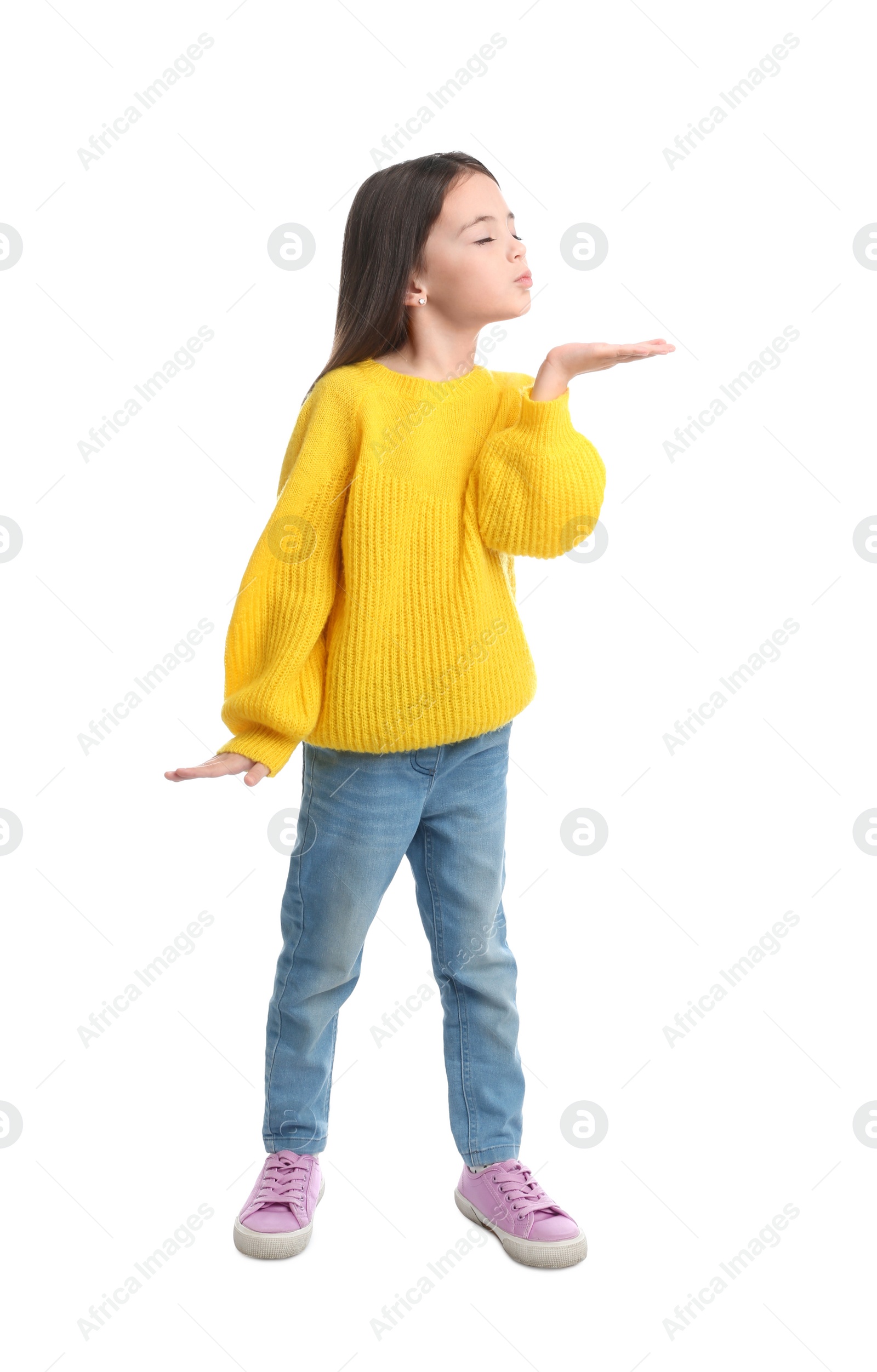 Photo of Cute little girl blowing air kiss on white background