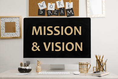Image of Modern computer with phrase MISSION AND VISION indoors 