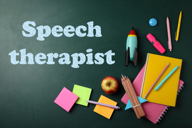 Bright toy rocket, school supplies and text Speech Therapist on chalkboard, flat lay 