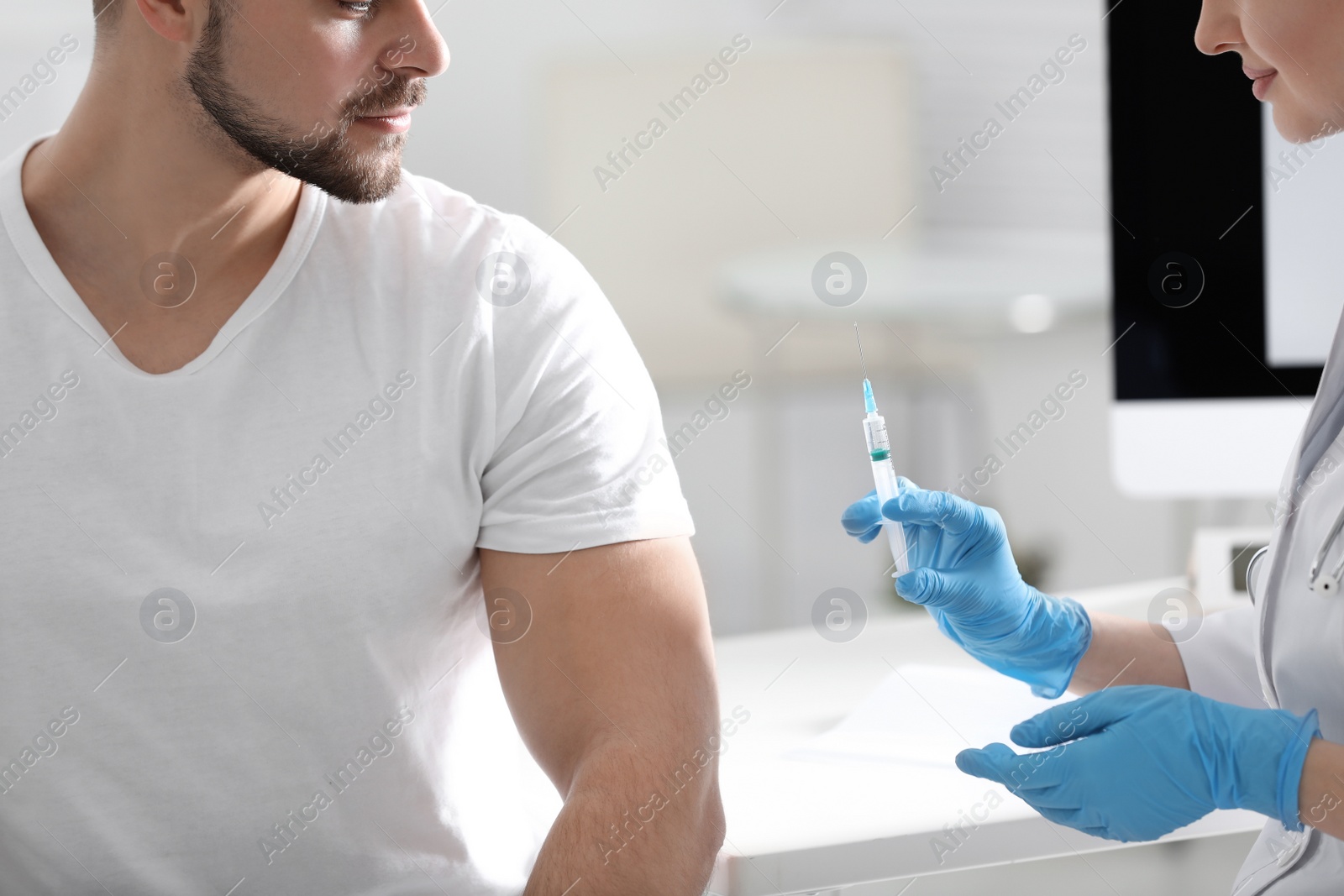 Photo of Doctor giving injection to patient in hospital, closeup. Vaccination concept