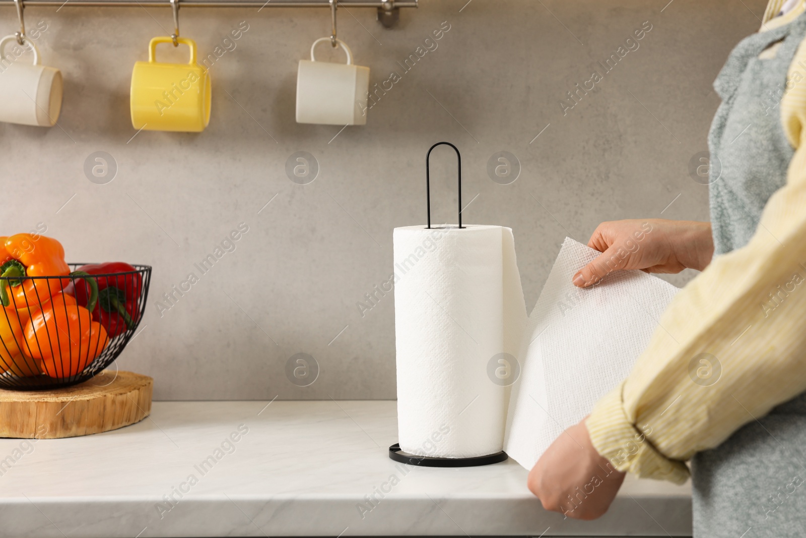 Photo of Woman using paper towels in kitchen, closeup