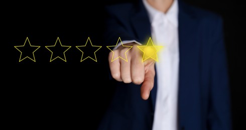 Image of Man choosing one star out of five on virtual screen against black background, closeup. Customer satisfaction score, banner design