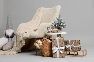 Stylish photo zone with armchair and Christmas decor in professional studio