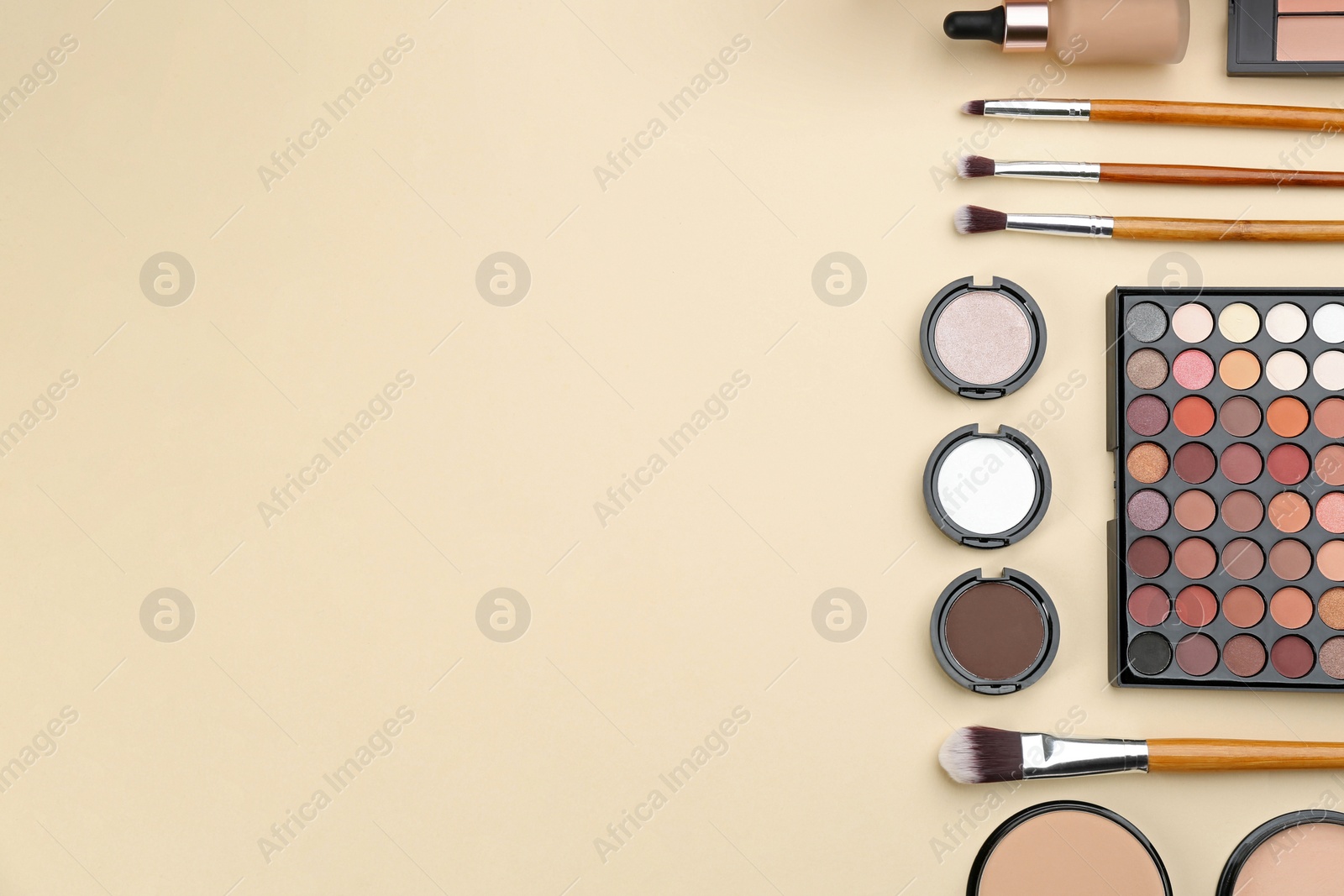 Photo of Flat lay composition with makeup brushes on beige background, space for text