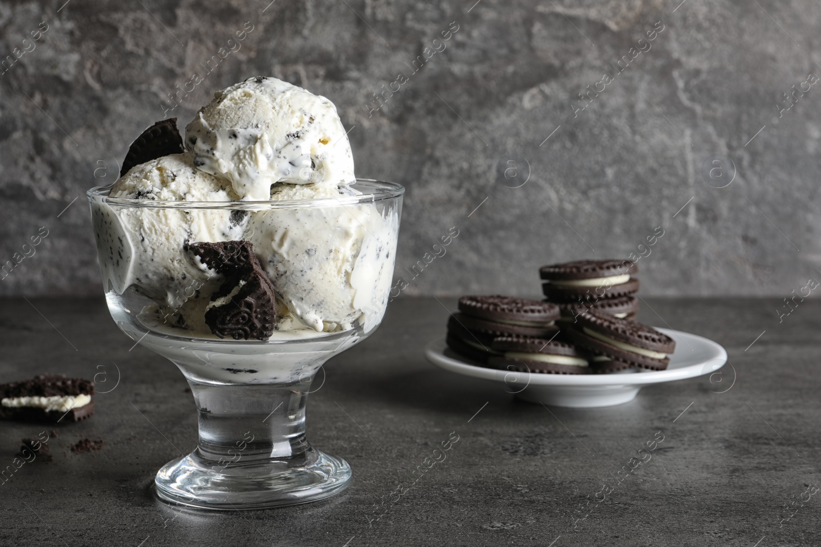 Photo of Bowl of chocolate cookies ice cream on table. Space for text