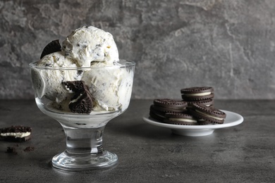 Bowl of chocolate cookies ice cream on table. Space for text