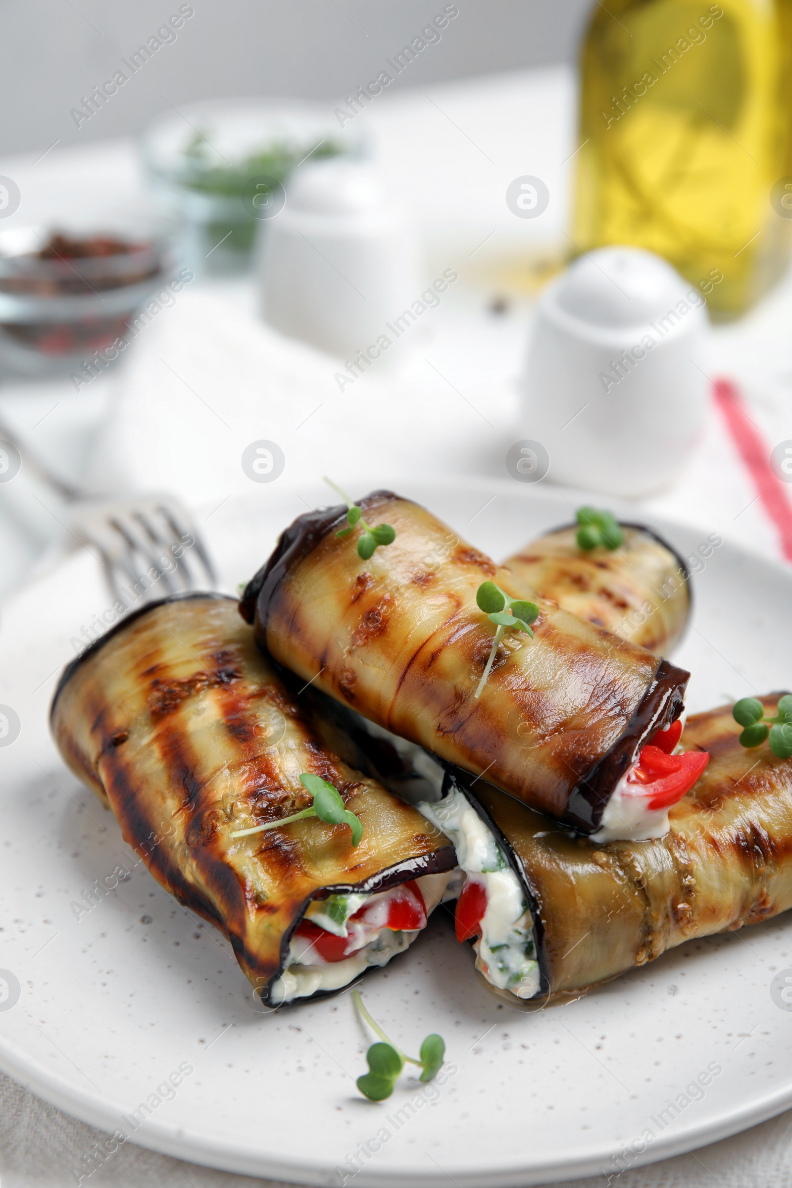 Photo of Delicious baked eggplant rolls served on table, closeup