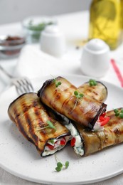 Delicious baked eggplant rolls served on table, closeup