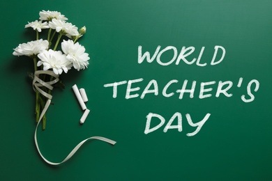 Image of Text World Teacher's Day, chalk and bouquet on greenboard, top view. Greeting card design